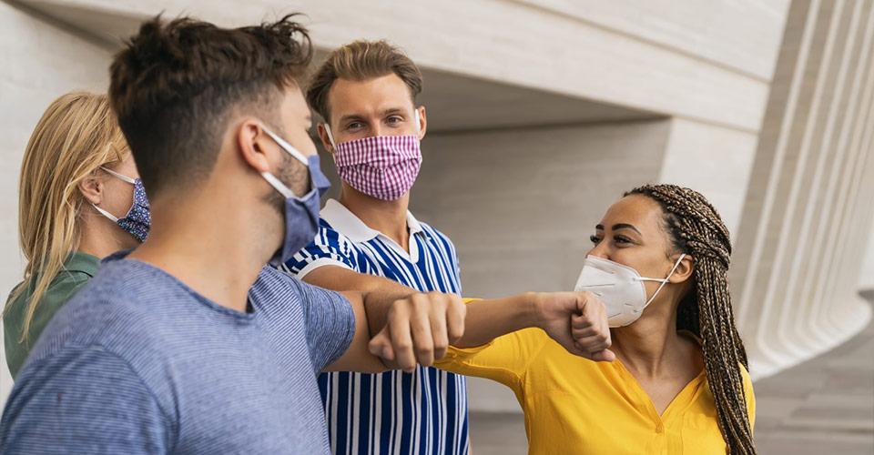 Young friends wearing face protective masks.